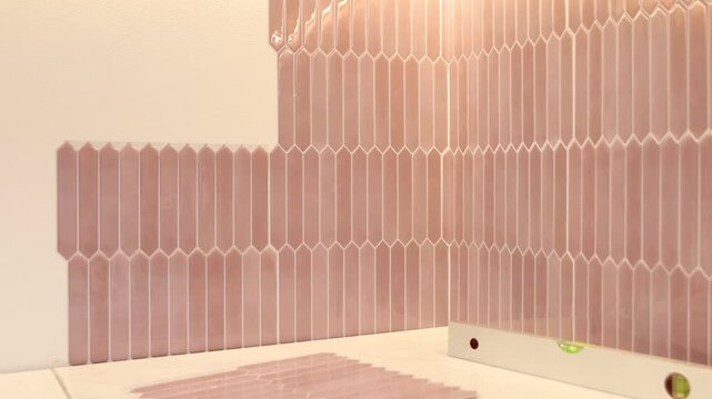 Stylish peel and stick tiles on wall and tools in kitchen