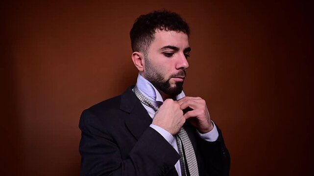 Young businessman preparing and adjusting his tie