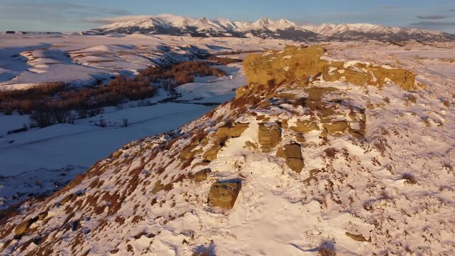 Sandstone formations and distant mountains and moon 