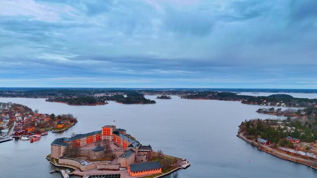 Approaching Vaxholm Fortress on the island of Kaskellet in the Stockholm Archipelago, Sweden. Dark rainy clouds cover the sky above.
