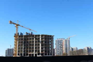 construction site with cranes, skyscrapers are being built in the city