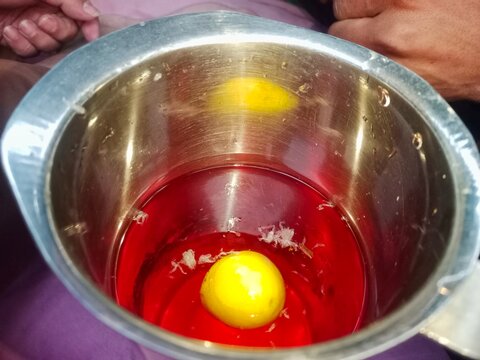 Traditional Ramadan red rose syrup drink with lemon in a steel vessel.
Refreshing Iftar beverage: Sweet rose sherbet with lemon for hydration.