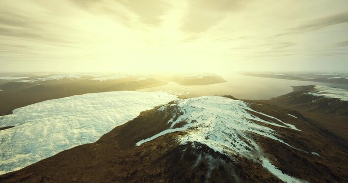 sunlit moraine slope with melting snow, rugged textures and small runoff streams, warm horizon glow, exploratory mood for outdoor adventure or study
