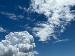 Blue sky with fluffy white clouds.