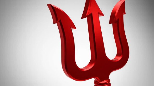 Shiny red devil's trident on a simple grey background