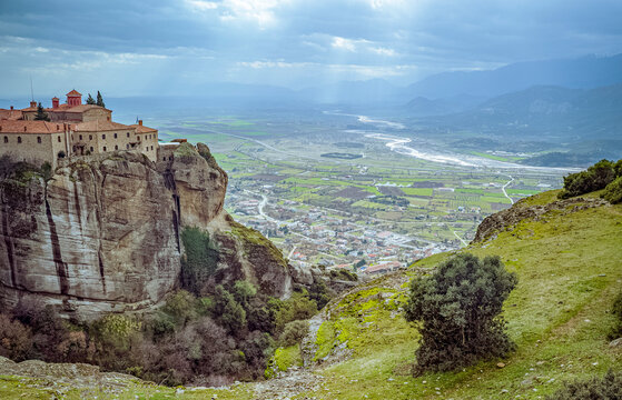 Greece, Meteora: Monastery on rock cliff overlooking valley and mountains