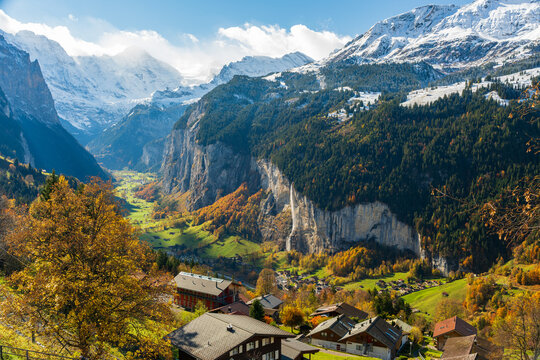 Lauterbrunnen valley aerial view from Wengen with autumn trees Staubbach Falls and snowy mountains. Wengen, Canton of Bern, Switzerland.