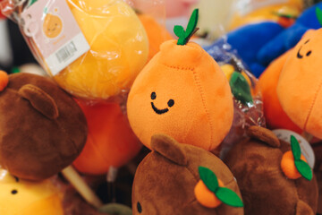 Tourist gifts and Korean souvenirs from Jeju Island, Jeju-do, South Korea, tangerine hallabong figures in orange color, knitted toys, fridge magnets, key ring keychain, a local gift vendor shop market