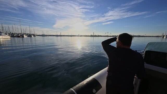 Sunrise on harbor as boat heads out with audio.
