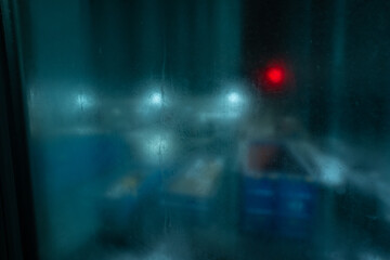 Fototapeta premium Atmospheric abstract view of colorful light spots through condensation during cold night