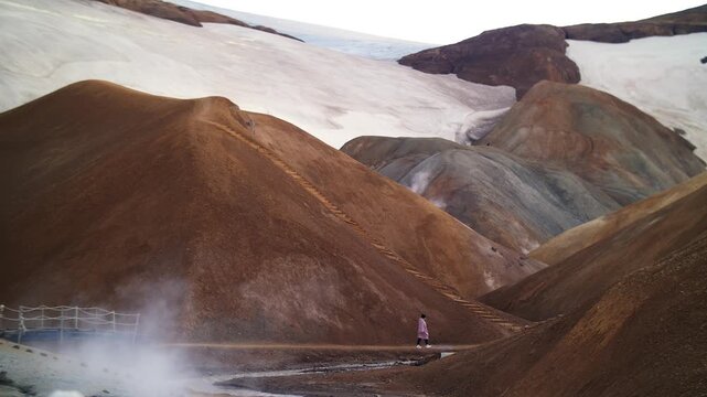 Hiker Walking Through Colorful Rhyolite Mountains in Iceland
