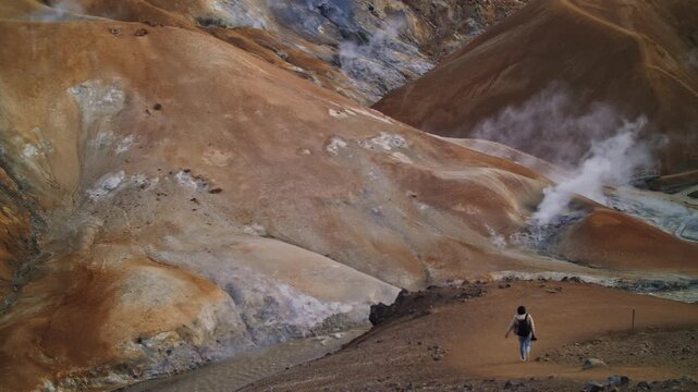 Hiker Descending into Geothermal Valley in Iceland