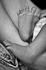 Fototapeta premium Newborn baby feet closeup in parent arms symbolizing love, care and family bonding
