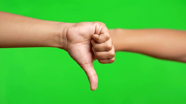 Hand displaying thumbs down gesture in isolated VIDEO on green screen