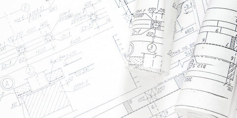 Architectural blueprints with rolled plans and solar panel, sustainable architecture and green building design, renewable energy integration, construction planning backgroun