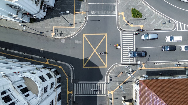 Urban traffic intersection with cars and motorcycles in Medan Indonesia showing city transportation activity aerial