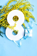 Mimosa yellow flowers on blue spring background, 8 march day festive background, mimose is...