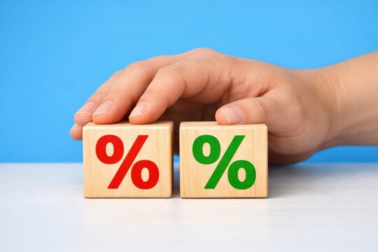 Percentage Dice: A hand delicately interacts with wooden dice, each adorned with a percentage symbol, representing concepts of financial gains and losses. 