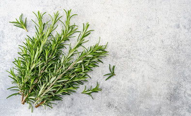 Rosemary branches on the old stone table background	
