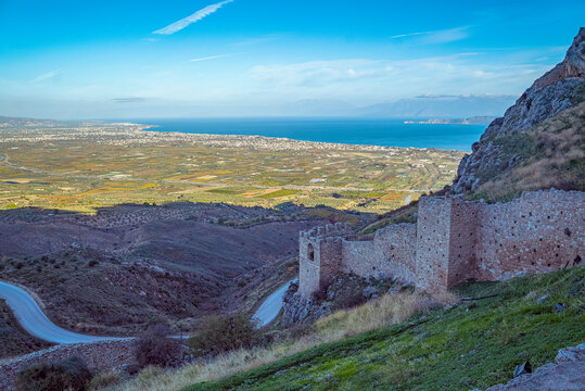 Acrocorinth, Corinth, Greece: Ancient stone castle ruins on a hillside overlooking sea