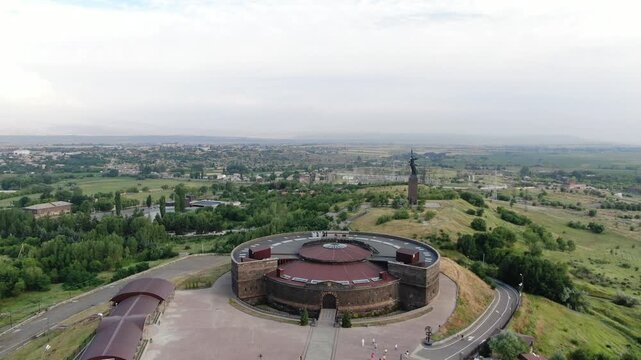 Aerial drone view of the historic Black Fortress, Sev Berd, and the Mother Armenia statue in Gyumri. The video shows the monumental architecture and the surrounding city landscape.