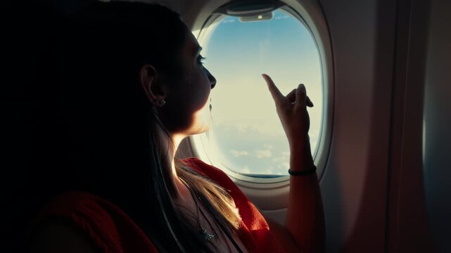 woman sitting on the plane next to the window