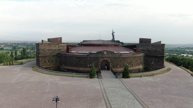 Aerial drone view of the historic Black Fortress, Sev Berd, and the Mother Armenia statue in Gyumri. The video shows the monumental architecture and the surrounding city landscape.