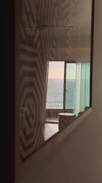 Vertical reflection of ocean sunset through a picture frame in a luxury hotel, Madeira