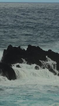 Vertical 4K waves crashing on volcanic rocks, 60fps high frame rate, Madeira