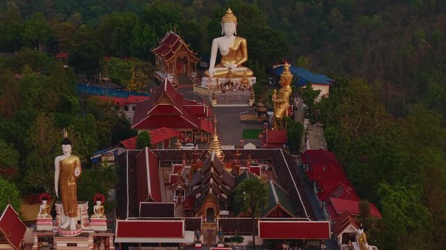 Aerial view of Wat Phra That Doi Kham, Buddha pagoda and golden chedi in Chiang Mai, Thailand.
