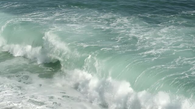 Powerful ocean wave crashing with white foam and turquoise water in motion