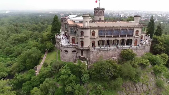 Chapultepec Castle stands majestically atop a hill overlooking a lush green forest and cityscape