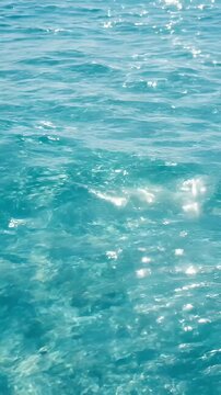 Turquoise sea water ocean surface sunlight reflection gentle waves clear water summer seascape aqua color rippling marine texture calm horizonless natural background outdoor tranquil turquoise sea