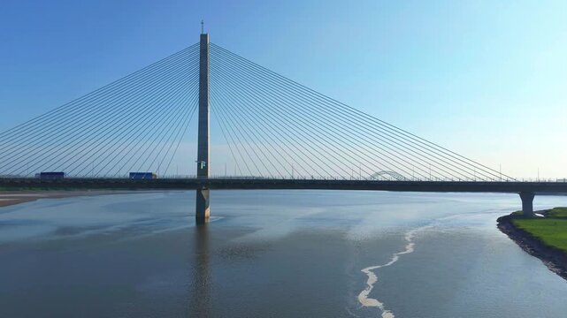 Liverpool, Merseyside, UK, June 19, 2025; Aerial 4K video footage of the Mersey Gateway toll bridge with stunning views over the River Mersey, Liverpool, UK.