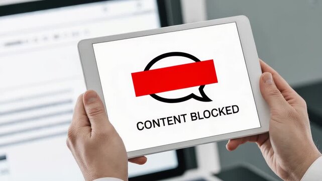Digital Content Blocked: A person holds a digital tablet displaying the stark message of Content Blocked, highlighting digital censorship and information control in the digital age.