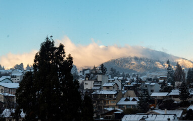   snow in Bariloche's main square, with Alpine-inspired architecture and the cathedral tower in the background. San Carlos de Bariloche, Patagonia, Argentina. Andes Mountains