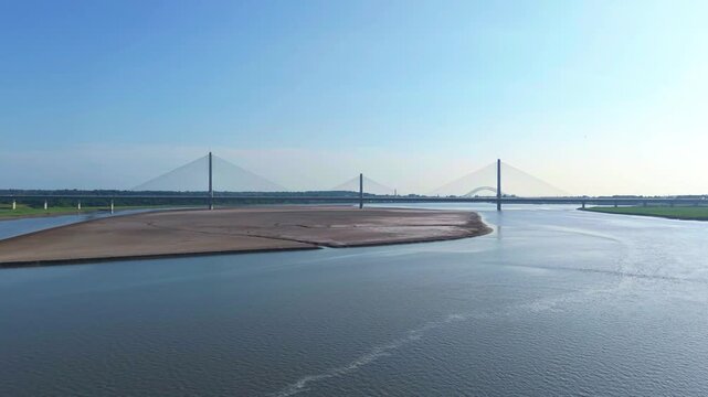 Liverpool, Merseyside, UK, June 19, 2025; Aerial 4K video footage of the Mersey Gateway toll bridge with stunning views over the River Mersey, Liverpool, UK.