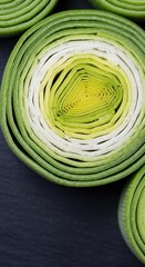 Obraz premium close-up of fresh green and white cabbage layers on dark slate background