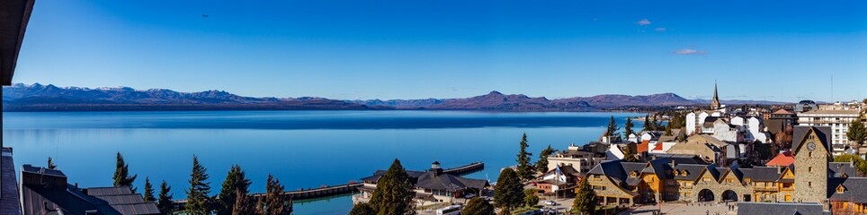 panorama of the lake   Bariloche's main square, with Alpine-inspired architecture and the cathedral tower  San Carlos de Bariloche, Patagonia, Argentina. Andes Mountains