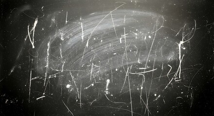 Dark, textured surface with light scratches and markings, suggestive of age or wear