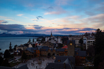 sunset over the city  Bariloche's main square, with Alpine-inspired architecture and the cathedral tower in the background. San Carlos de Bariloche, Patagonia, Argentina. Andes Mountains