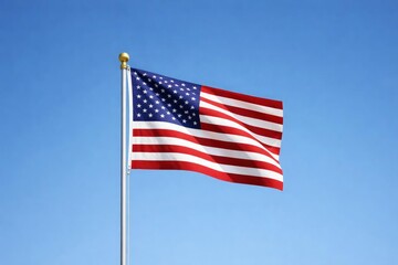 American flag waving on a silver pole against a clear blue sky