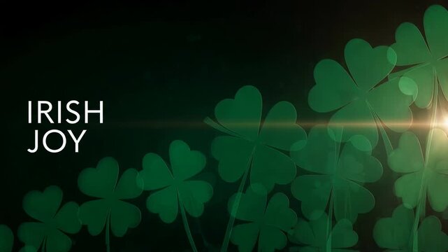 Irish joy lettering text moving over green shamrock clover background with light lens flare animation for Saint Patrick Day greeting card.