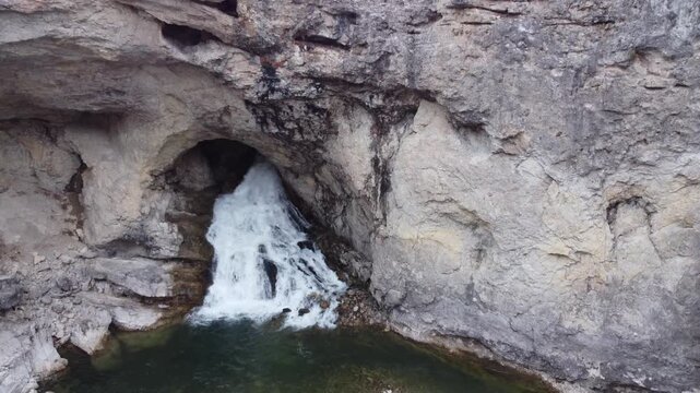 Natural bridge waterfall out of rock 