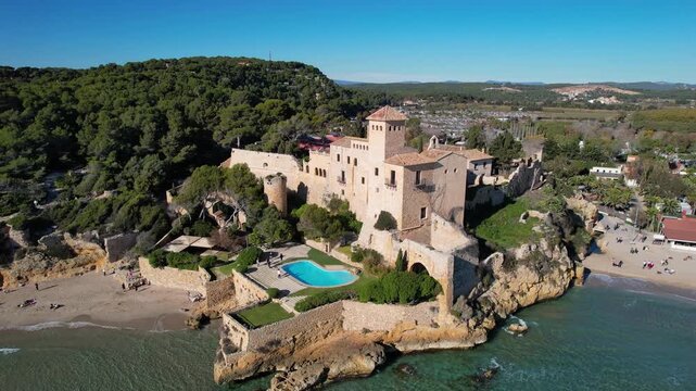 Aerial shot of Tamarit castle and beach on sunny day. Tamarit, Tarragona, Spain.