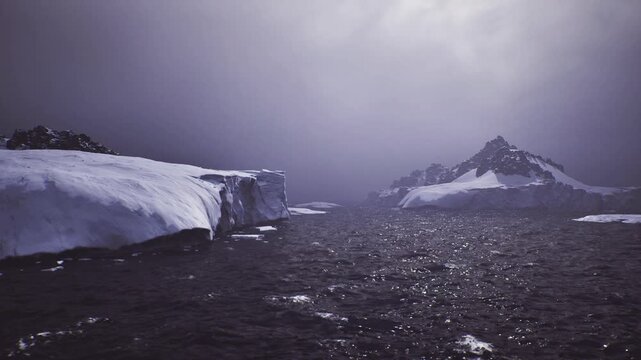 Moody polar seascape with icy floe and distant jagged peak, dark reflective water glittering under heavy clouds that let thin rays through atmosphere evokes