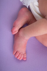 Little newborn baby feet during professional photoshoot