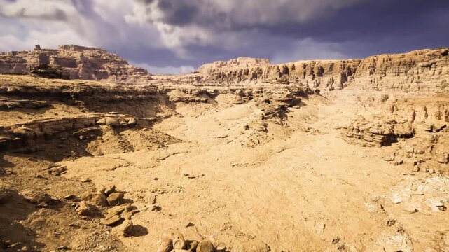 rocky foreground leading toward towering cliffs and textured ledges, high contrast light and shadow, strong perspective for adventure, hiking and editorial