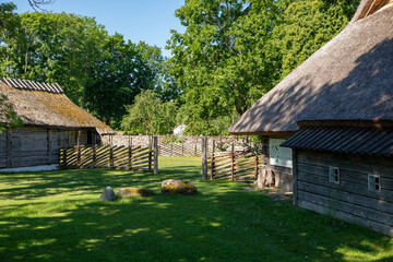 Fototapeta premium Traditional Estonian Farmstead With Thatched Roof Houses In Viki Saaremaa Estonia