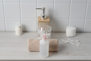 Countertop with bath supplies and personal care items in a bathroom setting during daylight